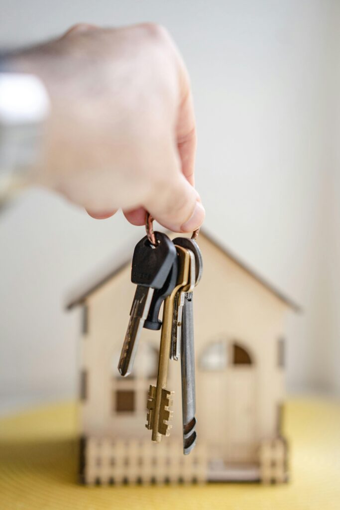 mortgage agent holding keys to firs time bought home