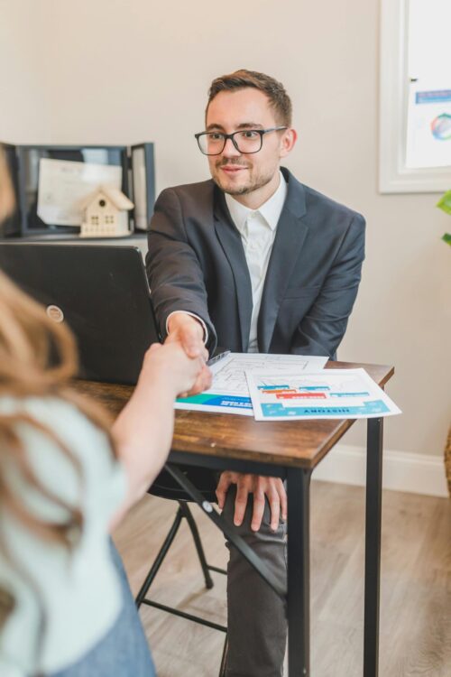 mortgage lender handshaking with client