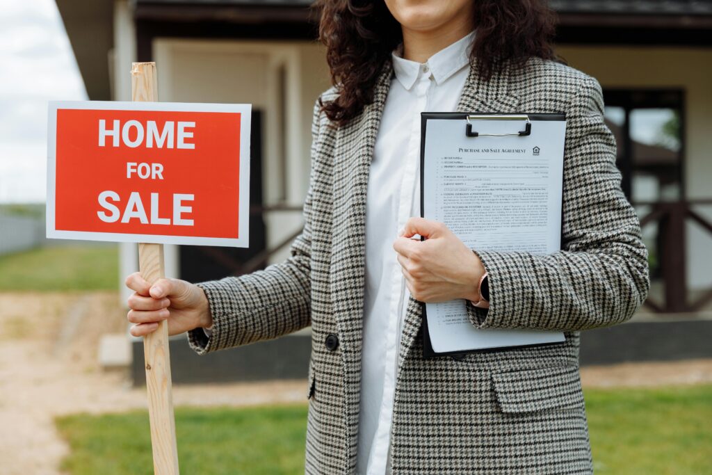 mortgage agent golding a home for sale sign